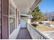 Front porch with wooden floor and brown shutters at 613 Lone Oak Dr, Lithonia, GA 30058