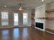 Open living room with a ceiling fan, fireplace and lots of natural light at 104 Stonehouse Dr, Cumming, GA 30040