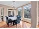 Bright dining room with a marble table, blue chairs, and an elegant chandelier fixture at 179 Worthington Way, Jonesboro, GA 30236