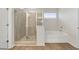 Modern bathroom with a glass-enclosed shower, soaking tub, and sleek fixtures offers a spa-like experience at 267 Arwen Drive (Lot 66), Mcdonough, GA 30252