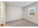 Bedroom featuring carpet, a window with blinds, and ensuite bathroom access at 267 Arwen Drive (Lot 66), Mcdonough, GA 30252