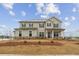 Charming two-story home featuring a symmetrical facade, complemented by dark shutters and a well-manicured front lawn at 267 Arwen Drive (Lot 66), Mcdonough, GA 30252