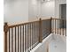 Upstairs hallway featuring wood and iron railing, neutral walls and plush carpet at 267 Arwen Drive (Lot 66), Mcdonough, GA 30252