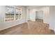 Bright living area featuring hardwood floors and a large window, offering a glimpse of the outdoor scenery at 267 Arwen Drive (Lot 66), Mcdonough, GA 30252