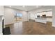 Open-concept living room and kitchen area with hardwood floors, fireplace, and a sliding glass door at 267 Arwen Drive (Lot 66), Mcdonough, GA 30252