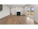 Spacious living room features hardwood floors, a fireplace, and a sliding glass door to the backyard at 267 Arwen Drive (Lot 66), Mcdonough, GA 30252