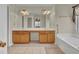 Large bathroom showcasing a soaking tub and a double sink vanity with cabinet storage and neutral paint color at 267 Windy Cir, Mcdonough, GA 30253