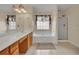Bright bathroom featuring a soaking tub, separate glass shower, and double sink vanity with cabinet storage at 267 Windy Cir, Mcdonough, GA 30253