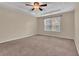 Spacious bedroom with a tray ceiling, fan, and window with natural light at 267 Windy Cir, Mcdonough, GA 30253