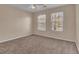 Bedroom with two windows, carpeted floors, neutral paint, and natural light creating a cozy atmosphere at 267 Windy Cir, Mcdonough, GA 30253