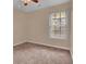 Neutral bedroom with a window, plush carpet, and ample natural light at 267 Windy Cir, Mcdonough, GA 30253
