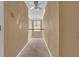 Upstairs hallway with carpeted floor, chandelier, ceiling fan, and natural light from the window at the end at 267 Windy Cir, Mcdonough, GA 30253