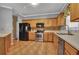 A practical kitchen features wooden cabinets, and stainless-steel appliances for a modern look and feel at 267 Windy Cir, Mcdonough, GA 30253