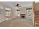 A welcoming living room with a cozy fireplace, plush carpet, and large windows for natural light at 267 Windy Cir, Mcdonough, GA 30253