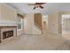 Bright living room with fireplace, ceiling fan, and a staircase leading to the upper level at 267 Windy Cir, Mcdonough, GA 30253