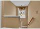 Staircase landing with a window, chandelier, and natural light at 267 Windy Cir, Mcdonough, GA 30253
