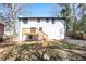 View of the rear of a two-story house with a wooden deck and a spacious, shady backyard at 3959 Emerald Springs Ct, Decatur, GA 30035