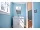 Charming powder room featuring a vanity with marble top and decorative mirror at 3959 Emerald Springs Ct, Decatur, GA 30035