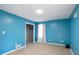 Bright bedroom features blue walls, neutral carpet, and closet space at 3959 Emerald Springs Ct, Decatur, GA 30035