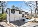 Two-story home featuring an attached garage and painted driveway at 3959 Emerald Springs Ct, Decatur, GA 30035