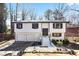 Charming two-story home with a black and white paint scheme, attached garage, and landscaped front yard at 3959 Emerald Springs Ct, Decatur, GA 30035
