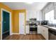 Well-lit kitchen featuring white cabinetry, stainless steel appliances, and warm wood flooring at 3959 Emerald Springs Ct, Decatur, GA 30035