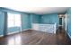 This living room is bright and airy with hardwood floors and light blue walls at 3959 Emerald Springs Ct, Decatur, GA 30035