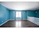 Bright living room boasts hardwood floors, blue walls, and a sun-filled window at 3959 Emerald Springs Ct, Decatur, GA 30035