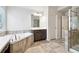 This bathroom offers a soaking tub, a shower with glass doors, and a vanity with neutral countertops at 6235 Banyan Trl, Cumming, GA 30028