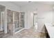 Bathroom features a stand-up shower with glass doors, neutral walls, and a large vanity with a countertop at 6235 Banyan Trl, Cumming, GA 30028