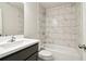 Modern bathroom featuring a white vanity and shower with marble-style tile at 6235 Banyan Trl, Cumming, GA 30028
