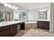 Luxurious bathroom features dual vanities, a soaking tub with tile surround, and ceramic tile flooring at 6235 Banyan Trl, Cumming, GA 30028