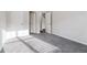 Bedroom with gray carpet and two doorways allowing for a variety of configurations at 6235 Banyan Trl, Cumming, GA 30028