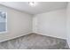 Bright bedroom with neutral carpet, light walls, white trim, and a closet at 6235 Banyan Trl, Cumming, GA 30028