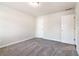 A bright, carpeted bedroom features neutral paint and two closets for ample storage space at 6235 Banyan Trl, Cumming, GA 30028