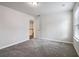 Bedroom featuring neutral carpet, light walls, white trim, a closet, and natural light at 6235 Banyan Trl, Cumming, GA 30028