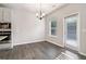 Bright dining area features hardwood floors, modern lighting and access to the backyard at 6235 Banyan Trl, Cumming, GA 30028