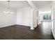 Spacious dining room featuring hardwood floors, modern lighting and access to the kitchen at 6235 Banyan Trl, Cumming, GA 30028