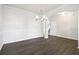 Open-concept dining room with modern chandelier and easy access to stairway at 6235 Banyan Trl, Cumming, GA 30028