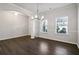 Dining room with dark wood floors, modern chandelier, and lots of natural light at 6235 Banyan Trl, Cumming, GA 30028