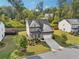 Attractive two-story home with well-maintained landscaping, a two-car garage, and gray stone facade at 6235 Banyan Trl, Cumming, GA 30028