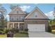 Charming two-story home with a brick exterior, well-manicured landscaping, and a two-car garage at 6235 Banyan Trl, Cumming, GA 30028