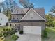 Charming two-story home with brick and siding, complemented by a well-manicured front yard at 6235 Banyan Trl, Cumming, GA 30028