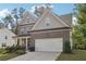 Beautiful two-story house boasting a brick exterior, a two-car garage, and a well-cared-for garden at 6235 Banyan Trl, Cumming, GA 30028