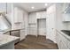 Bright kitchen features stainless steel appliances, granite countertops, and hardwood floors at 6235 Banyan Trl, Cumming, GA 30028