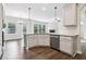 Bright kitchen with granite countertops, stainless steel appliances and hardwood floors at 6235 Banyan Trl, Cumming, GA 30028
