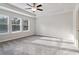 Spacious main bedroom with tray ceiling, fan, and large windows for natural light at 6235 Banyan Trl, Cumming, GA 30028