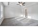 Main bedroom with tray ceilings, ceiling fan, and lots of natural light from large windows at 6235 Banyan Trl, Cumming, GA 30028