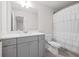 Bright bathroom featuring a gray vanity, white countertop, and a shower with a white ruffled curtain at 6701 Cedar Glen Rd, Peachtree Corners, GA 30071