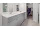 Bathroom with double vanity and sink, as well as access to walk-in closet at 6701 Cedar Glen Rd, Peachtree Corners, GA 30071